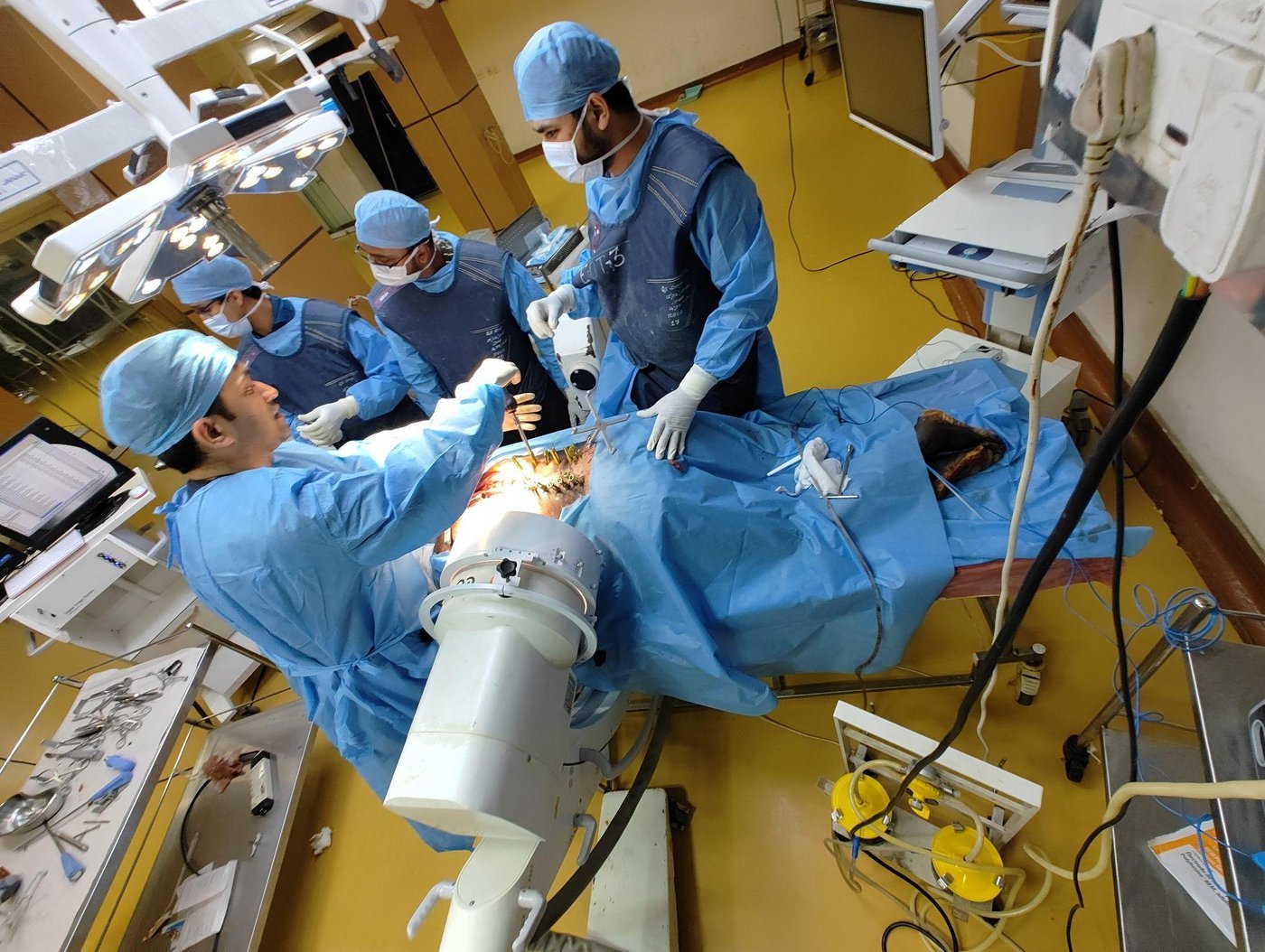 Team performing an MIS procedure with C-Arm imaging